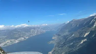 Sightseeing flight over mountains and Garda Lake.
