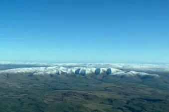 Crisp winter’s morning with snow covered hills