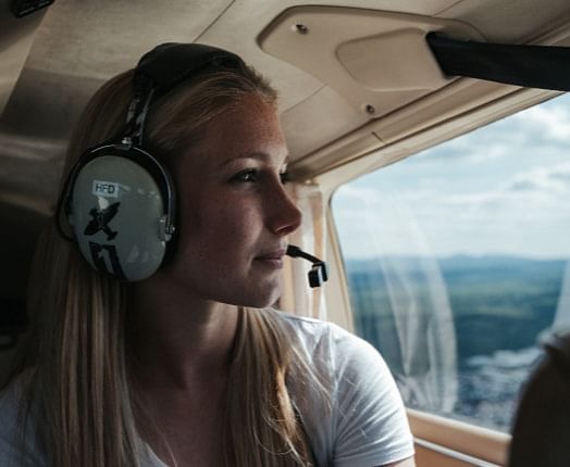 A woman looks out of the cockpit window