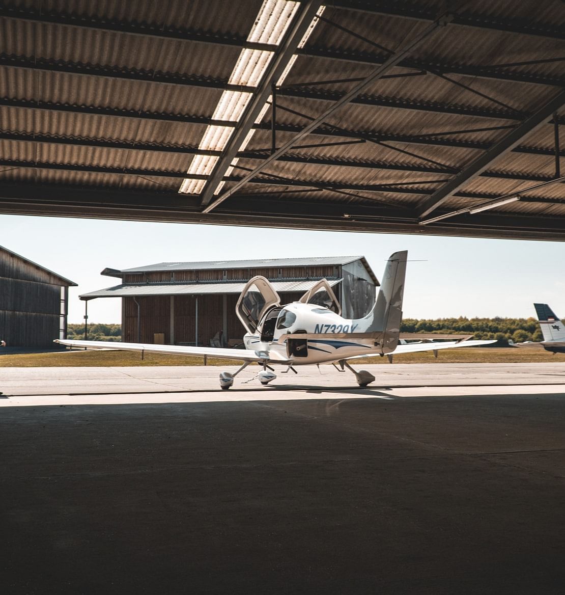 Light aircraft parked in a hangar