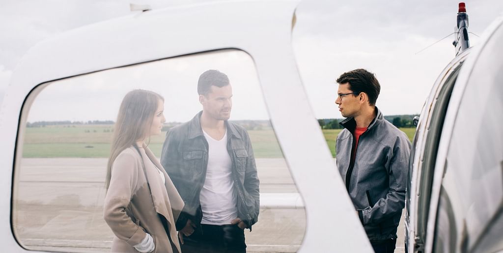 Three people prepare for the flight