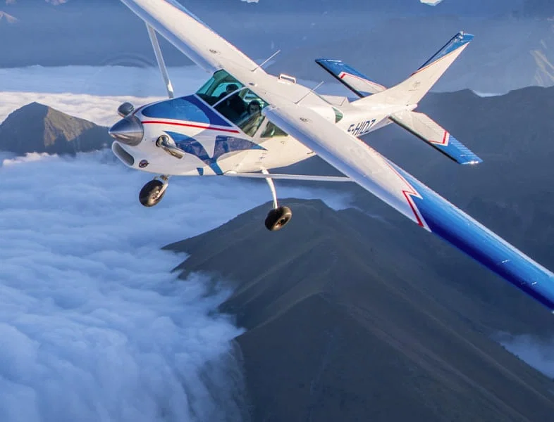 Passengers in a private plane above the mountains