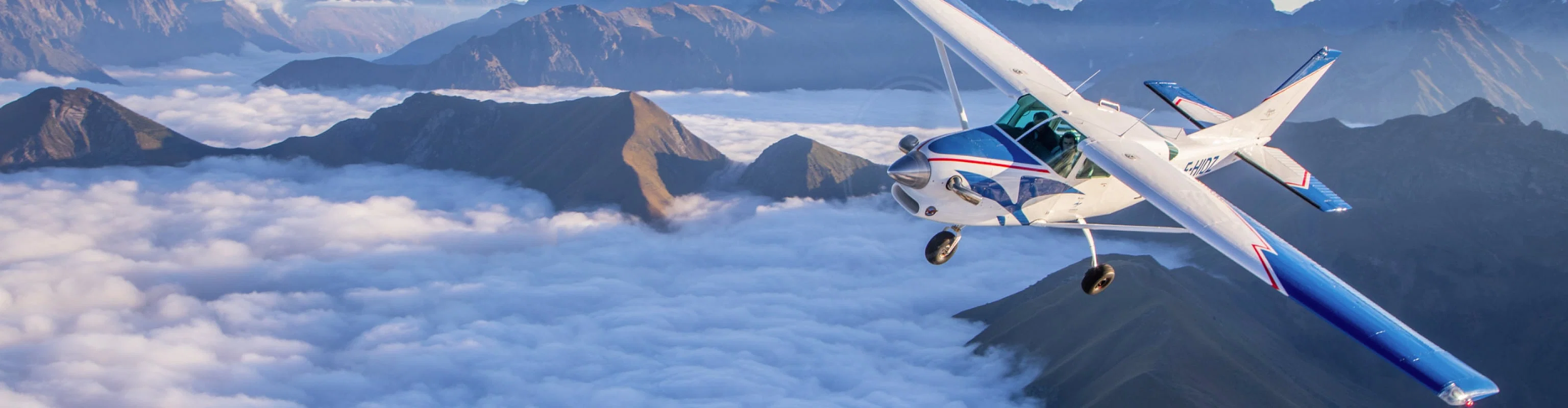 Passengers in a private plane above the mountains