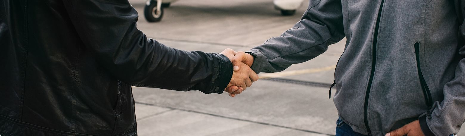 Two men shake hands