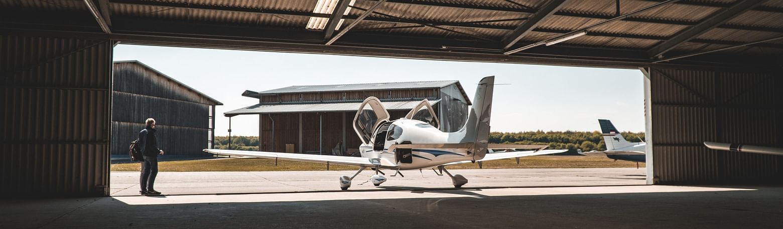 Light aircraft parked in a hangar