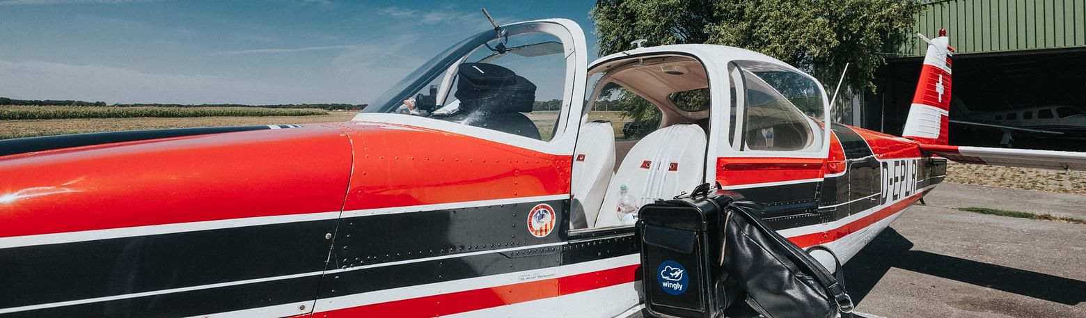 A light aircraft parked outside on a sunny day